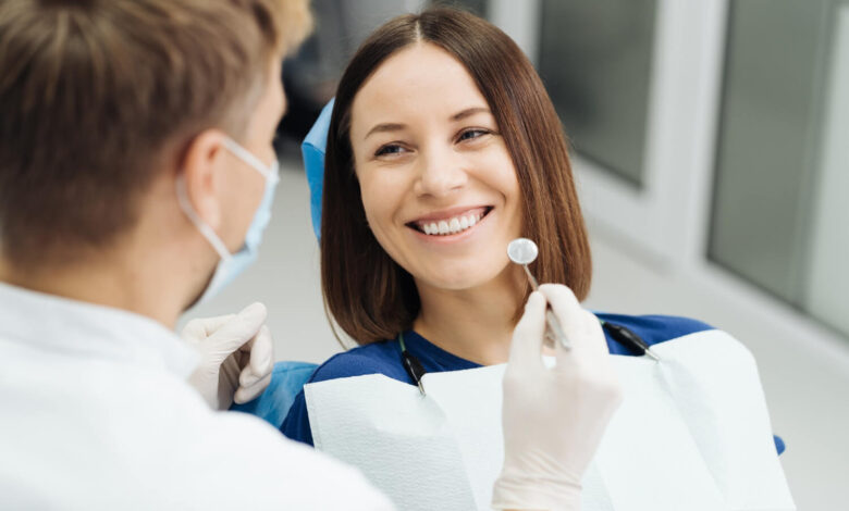 Smiling woman sitting in a dental chair during a check-up at the dentist